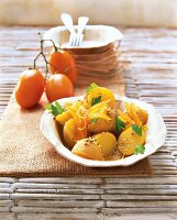 Unpeeled potato salad with sesame in rustic bowl