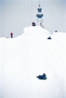 People sledding on snow in winter, Salzburg, Austria