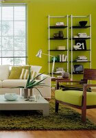 Living room with green walls and white sofa on fluffy carpet