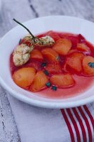 Peach compote with baked elderflower on plate