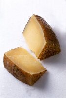 Close-up of pieces of manchego on white surface