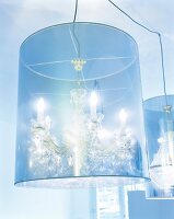 Close-up of illuminated blue cylindrical chandelier lamp