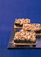 Close-up of pear cake with poppy seed on blue background