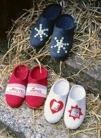Three felt slippers in red by name, white photos, blue with sequins