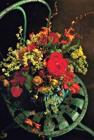 Blumenstrauß mit Sommerblumen in Vase Dekoration, auf Stuhl, innen