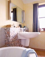 Bath tub and sink with mosaic tiles in bathroom