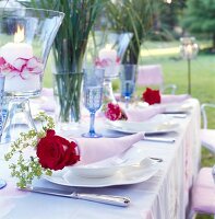 Summer table in garden with decorated dining table