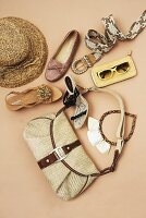 Ethnic and safari shoes, belt, handbag, hat and other accessories on beige background