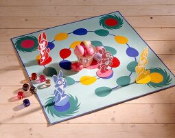 Dice game with bunnies and eggs on wooden floor