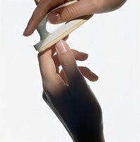 Close-up of woman's fingernails being buffed with polishing pad