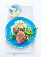 Fried tuna with turnip puree and celery on plate
