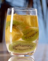 Kiwi and mango in glass of water