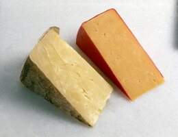 Red and yellow cheddar cheese on white background