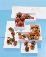 Several snack dishes on white serving dishes against blue background