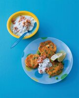 Pea cakes with shrimp sour cream on plate against blue background
