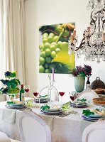 Table decorated with plate, tiered stand, flower vase and other accessories