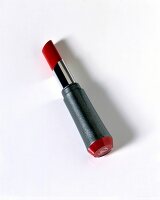 Classic red lipstick on white background