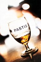 Glass of pastis on wooden table