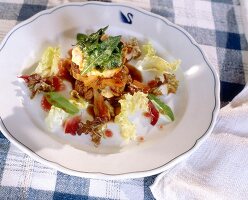 Dumplings salad with sweetbreads on plate