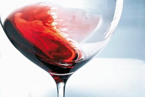 A glass of red wine being swirled
