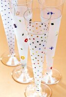 Close-up of champagne flutes with multi-coloured motifs