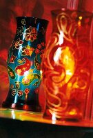 Close-up of two brightly painted lanterns