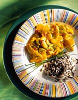 Turkey and pineapple curry with rice on plate