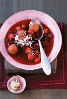 Beetroot soup with meat, diced potatoes and dill in bowl