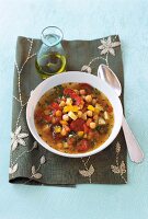 Spanish chickpea soup with peppers, potatoes and tomatoes in bowl