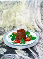 Chocolate mousse with mint salad on plate