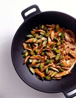 Turkey meat with green asparagus in wok