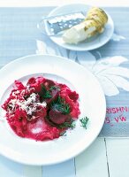 Pasta with beetroot and horseradish served on plate