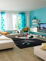 Living room with blue wall, sofa, table, TV and curtains