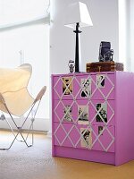 Dresser in purple with elasticated mesh and photos decorated in room