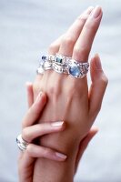 Close-up of woman's hand wearing big rings in fingers