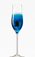 Close-up of 'Blue Lagoon' with curacao, cherry brandy and champagne in champagne flute