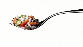 Close-up of risotto with sausage and tomato on serving fork, New Orleans, USA