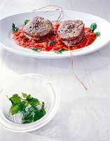 Beef medallions with pizzaiola sauce on serving dish