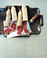 Four different types of Italian salami on tray
