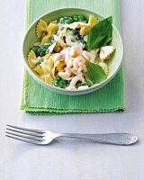 Farfalle with shrimp and peas in bowl