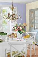 Dining table with flower pot and chandelier