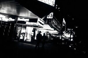 People strolling at night near shops, Hamburg, Germany, black and white