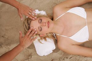 Overhead view of pretty woman receiving massage, eyes closed