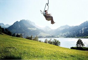 Touristen im Sessellift in luftiger Höhe, Drei-Seen-Landschaft