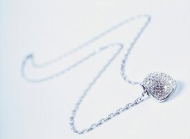 Chain with diamond pendant in white gold on white background