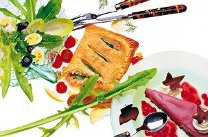 Puff pastry with spinach and salmon, red wine pie and quail egg salad on white background