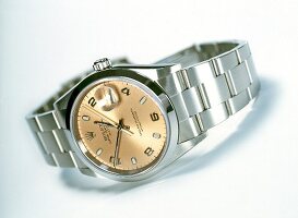 Close-up of stainless steel wristwatch on white background