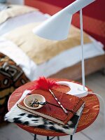 A note book and a lamp on an ethnic-style bedside table
