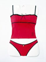 Close-up of red lingerie with black straps on mannequin
