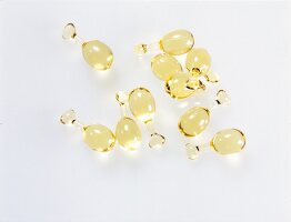 Yellow oil capsules on white background